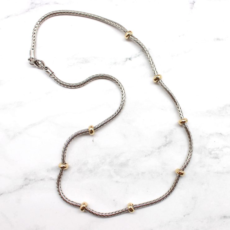 A photo of the Gold Beads Silver Chain product