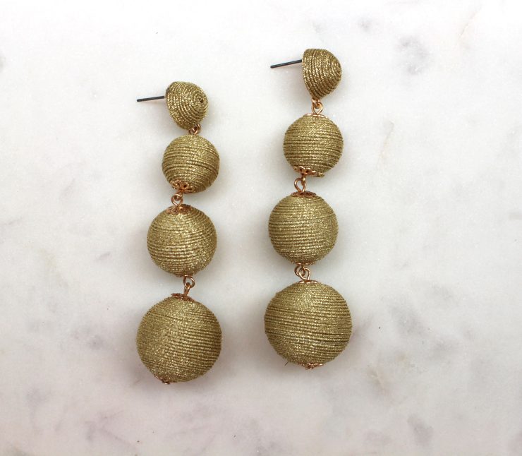 A photo of the Shimmer Thread Ball Earrings product