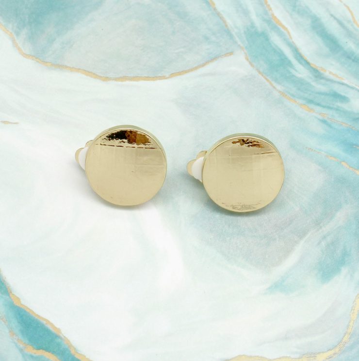 A photo of the Gold Button Clip-On Earrings product