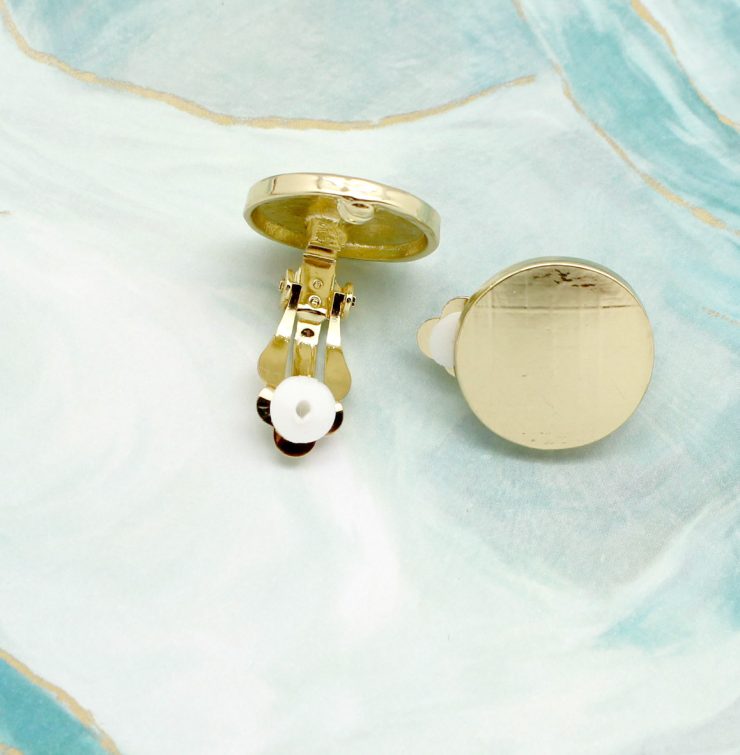 A photo of the Gold Button Clip-On Earrings product