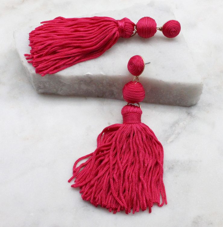 A photo of the Olé Tassel Earrings In Fuchsia product