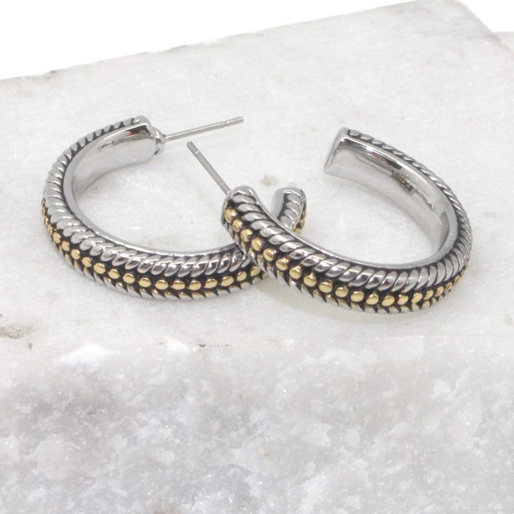 A photo of the Two Tone Braided Hoop Earrings product