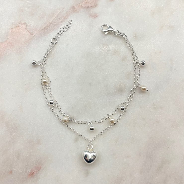 A photo of the Pearl & Silver Beaded Charm Bracelet product