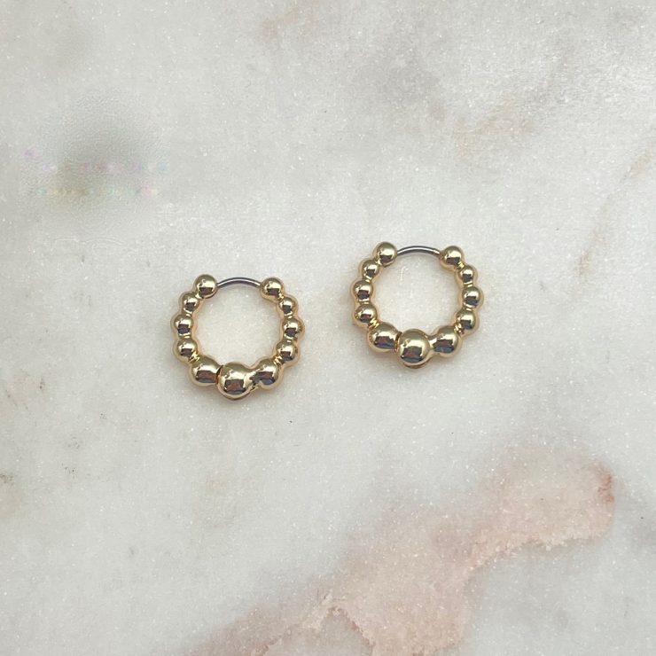 A photo of the Bubble Hoop Earrings in Gold product