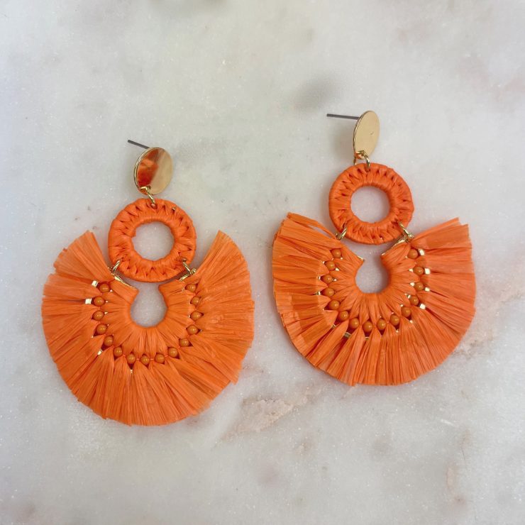 A photo of the Lolita Raffia Earrings in Orange product