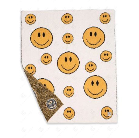 A photo of the Comfy Luxe Smiley Face Blanket product