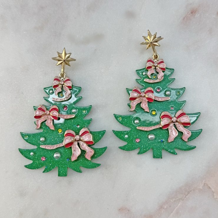 A photo of the Pink Bow Christmas Tree Earrings product