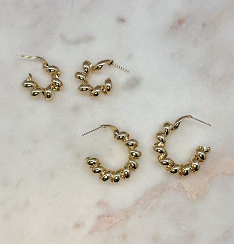 A photo of the Twisted Coil Hoops in Gold product