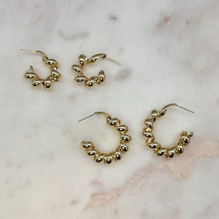 A photo of the Twisted Coil Hoops in Gold product