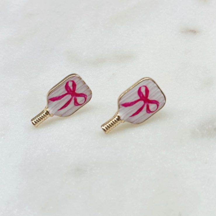 A photo of the Pink Bow Pickleball Studs in Stripes product