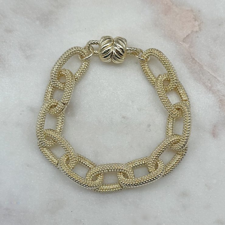 A photo of the Gold Textured Magnetic Link Bracelet product