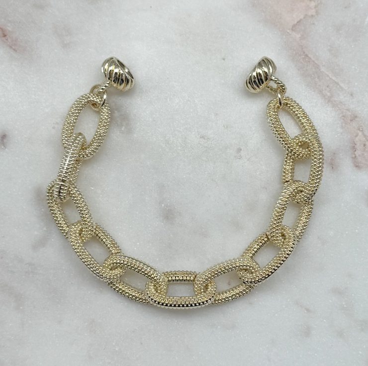 A photo of the Gold Textured Magnetic Link Bracelet product